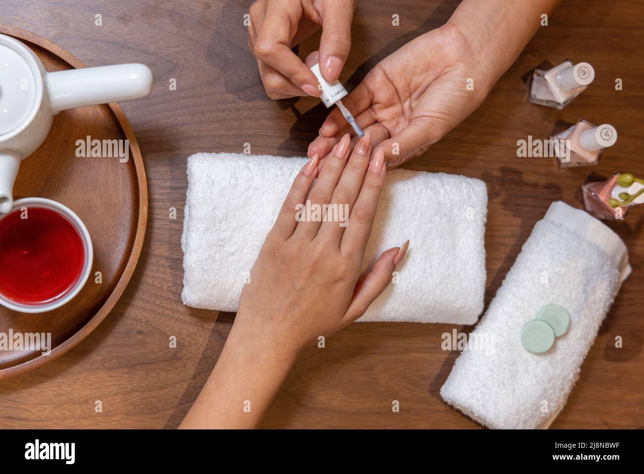 Nail artist polishing nails for client Stock Photo Alamy