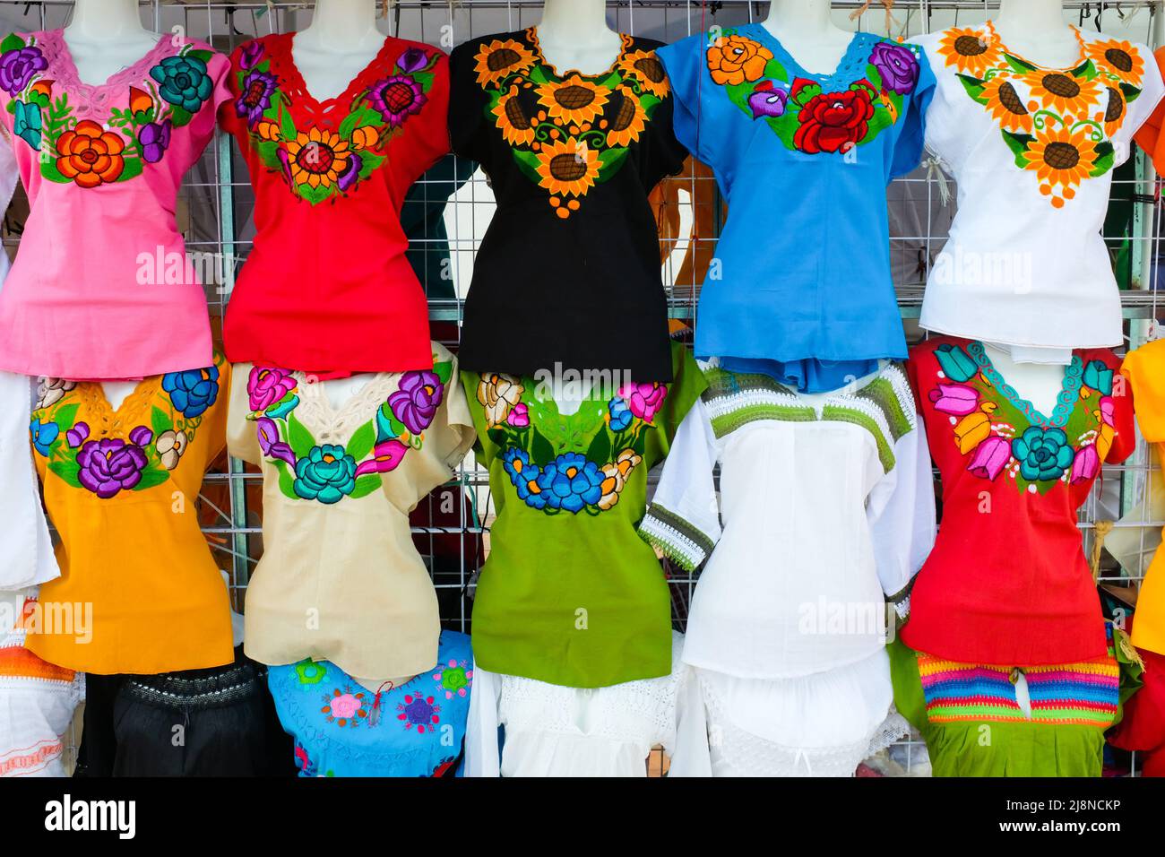 Display of women clothes for sale with traditional Mexican flower patterns, Historic center of San Francisco de Campeche, Campeche, Mexico Stock Photo