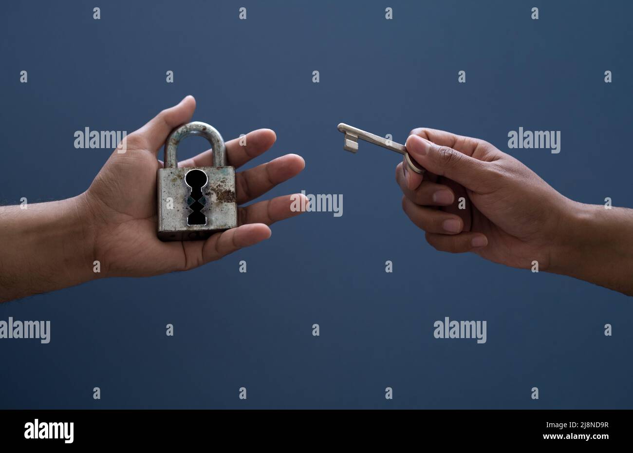 Hands holding lock and key on isolated background. Concept of solving