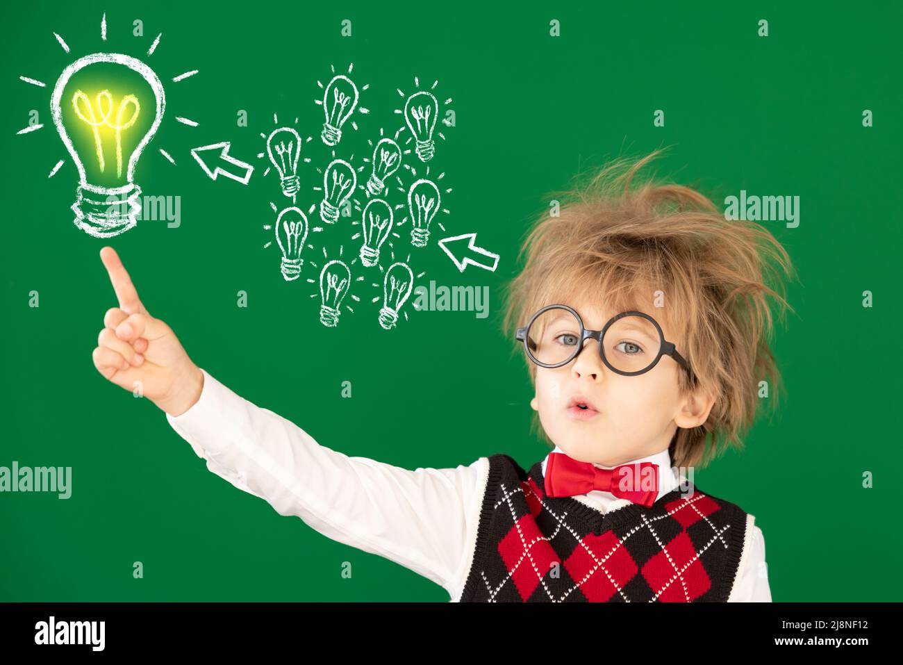 Funny child student in class. Happy kid against green chalkboard. Education concept. Back to school Stock Photo