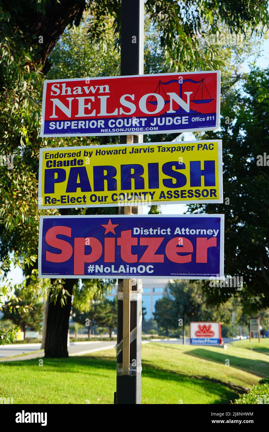 Irvine, CA, USA - May 16, 2022: Orange County campaign signs affixed to light pole. Stock Photo