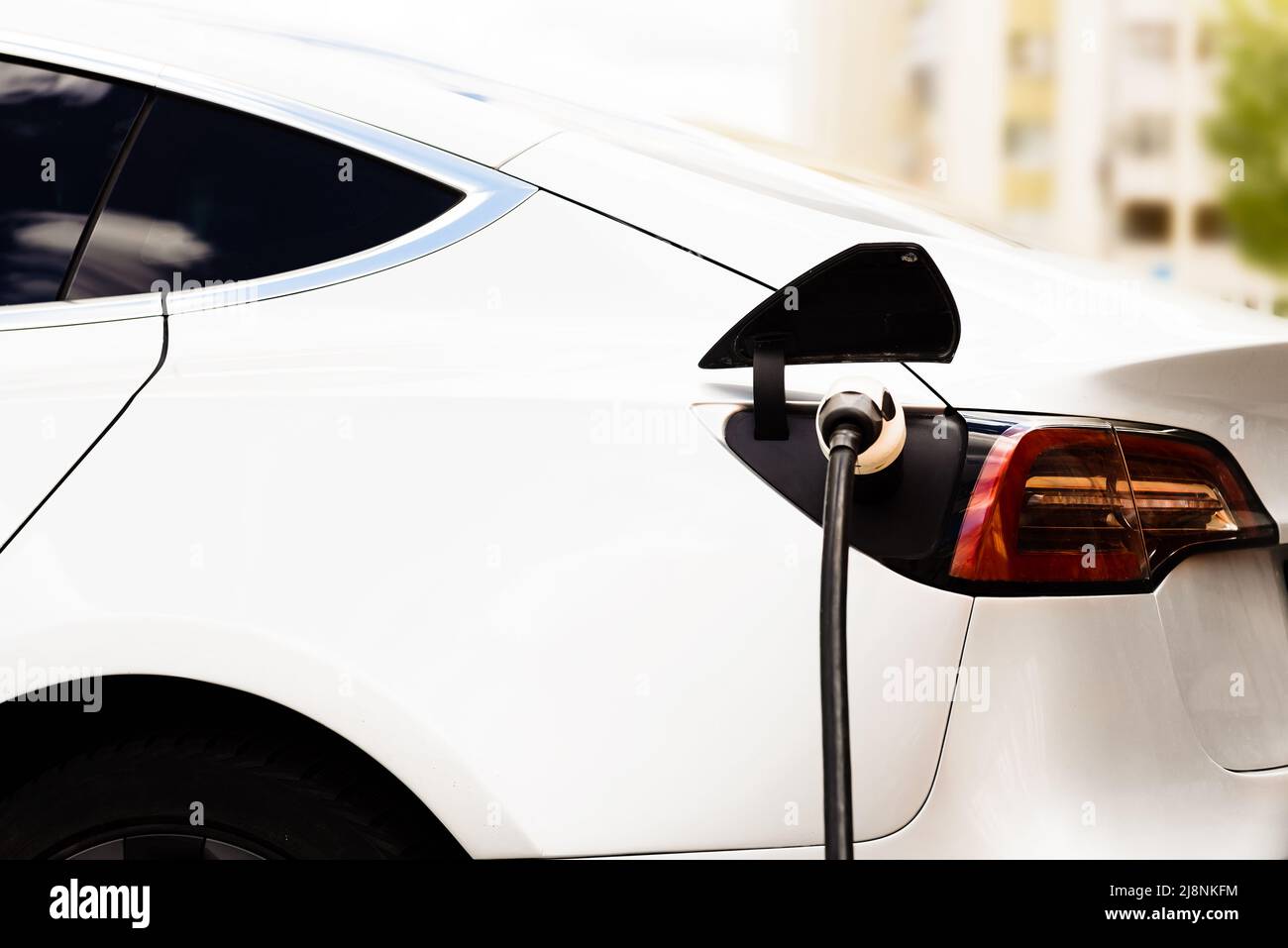 Electric car at the charging station. Ecology. Eco-friendly transport ...