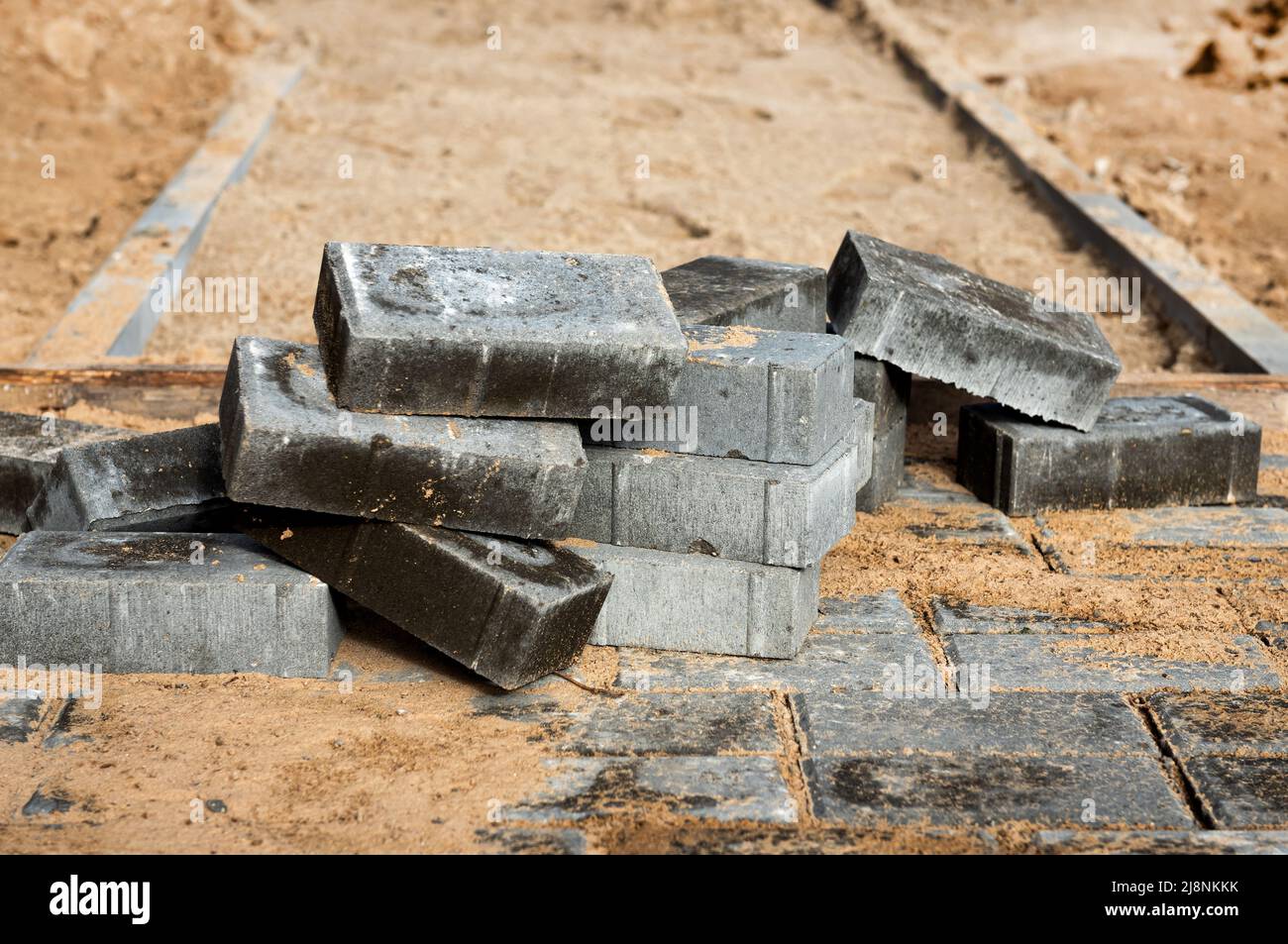 Laying the path with paving bricks. Street improvement. Construction of pedestrian roads Stock Photo