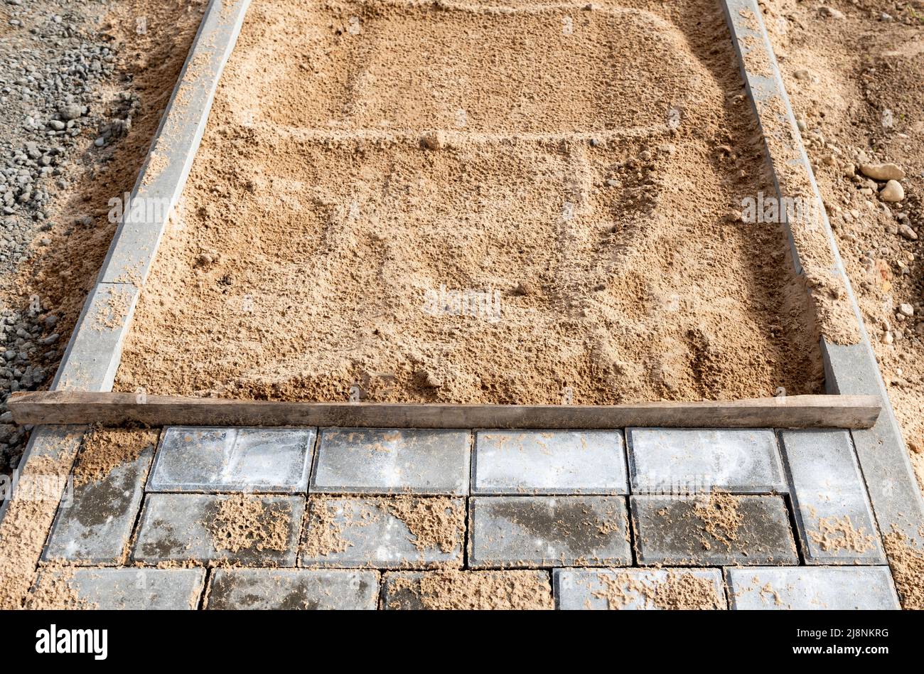 Laying the path with paving bricks. Street improvement. Construction of pedestrian roads Stock Photo