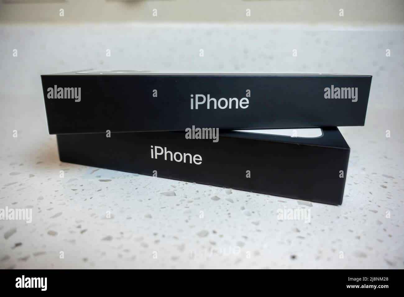 Seattle, WA USA - circa May 2022: View of two iPhone 13 Pro boxes on a kitchen counter inside a home Stock Photo