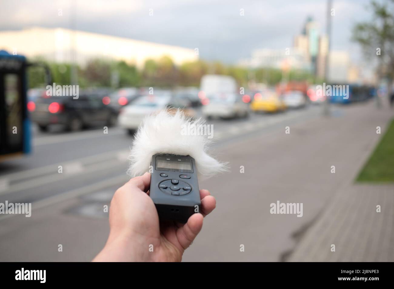 Voice recorder in hand. Recording sound effects, and ADR. Sounds of urban life Stock Photo Alamy