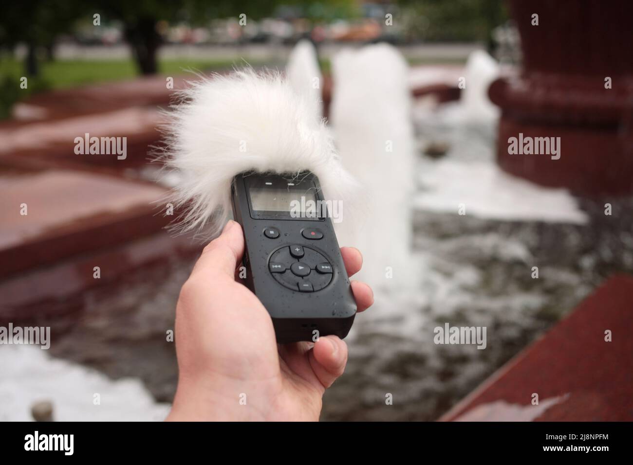 Voice recorder in hand. Recording sound effects, and ADR. Sounds of urban life Stock Photo Alamy