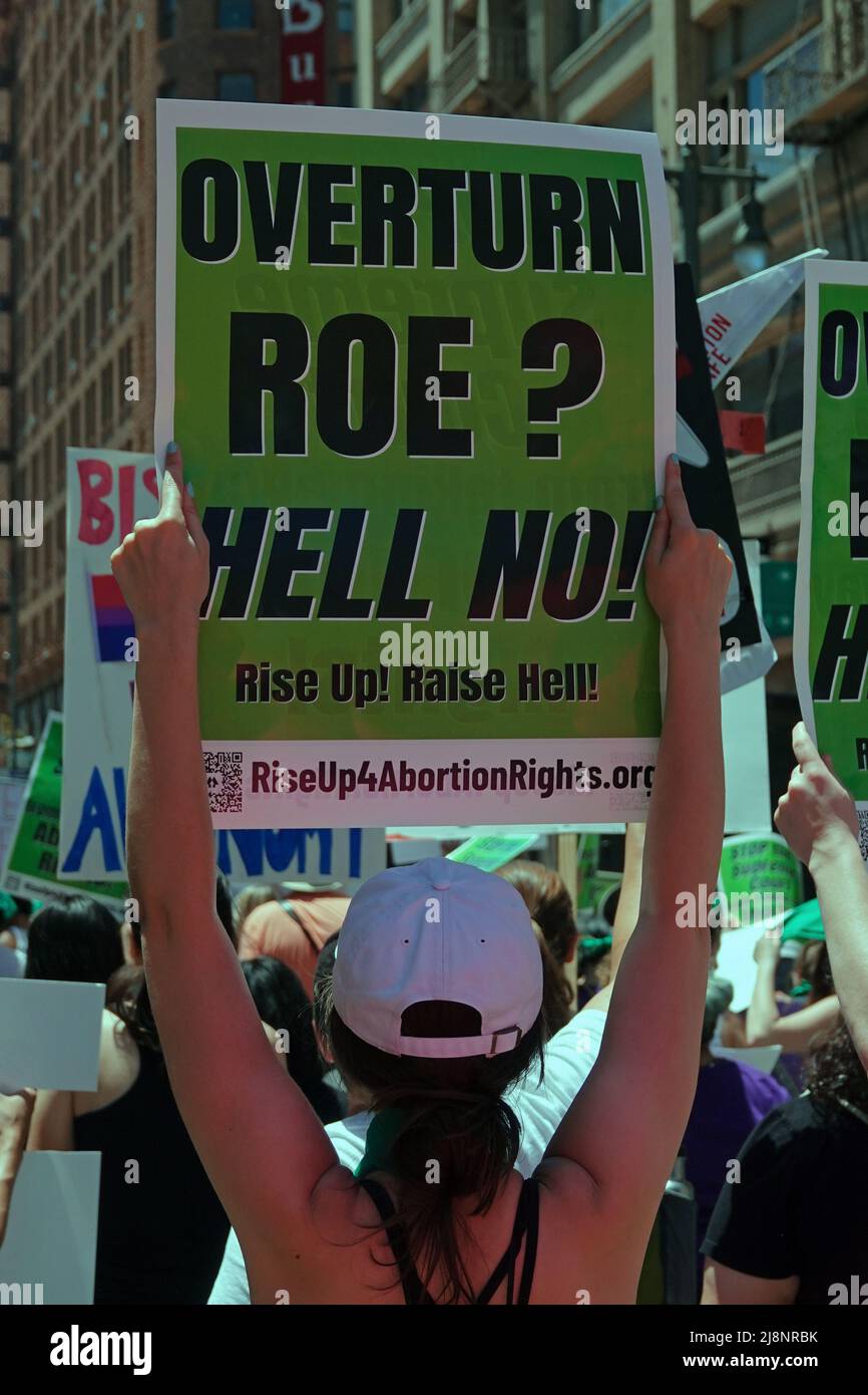 Los Angeles, CA / USA - May 14, 2022: A sign reads “OVERTURN ROE? HELL NO! Rise Up! Raise Hell!” at a march supporting women’s reproductive rights. Stock Photo