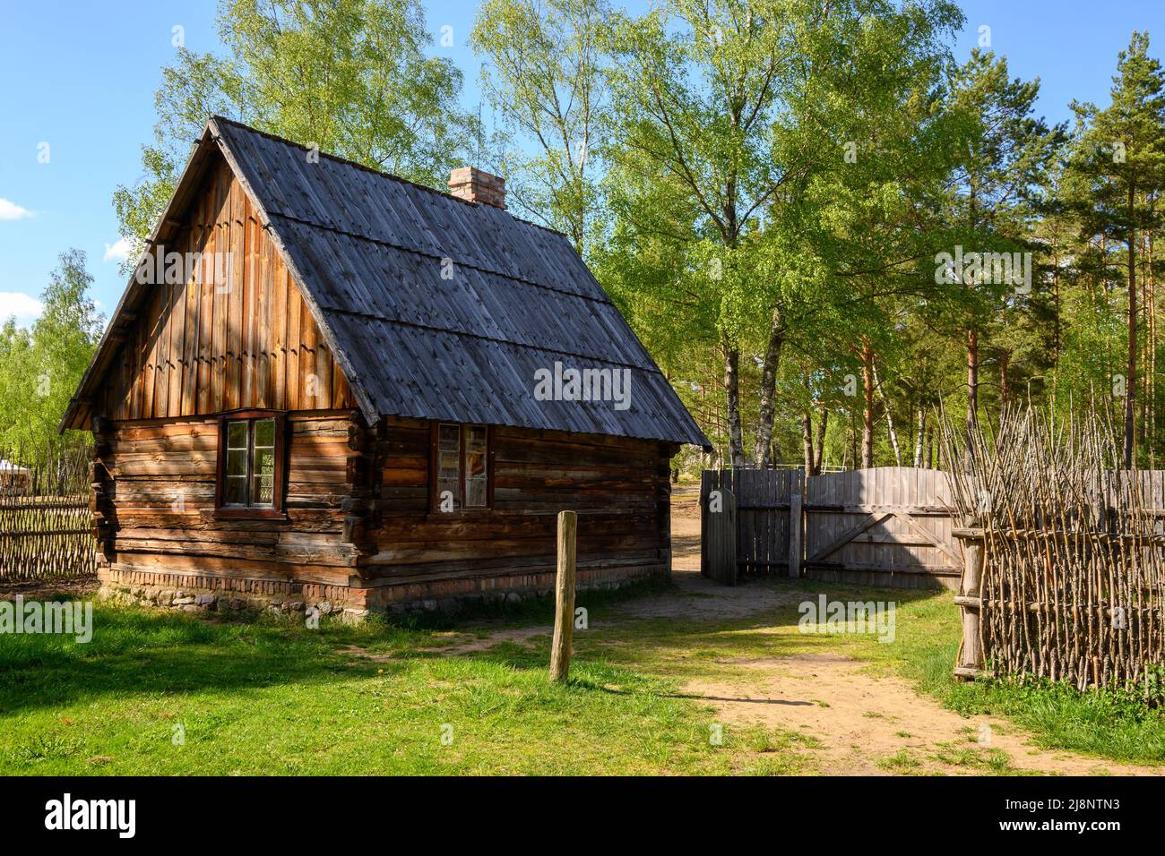 Wdzydze Kiszewskie, Poland - May 15, 2022: Wooden cottage in Kashubian Ethnographic Park in Wdzydze Kiszewskie Stock Photo