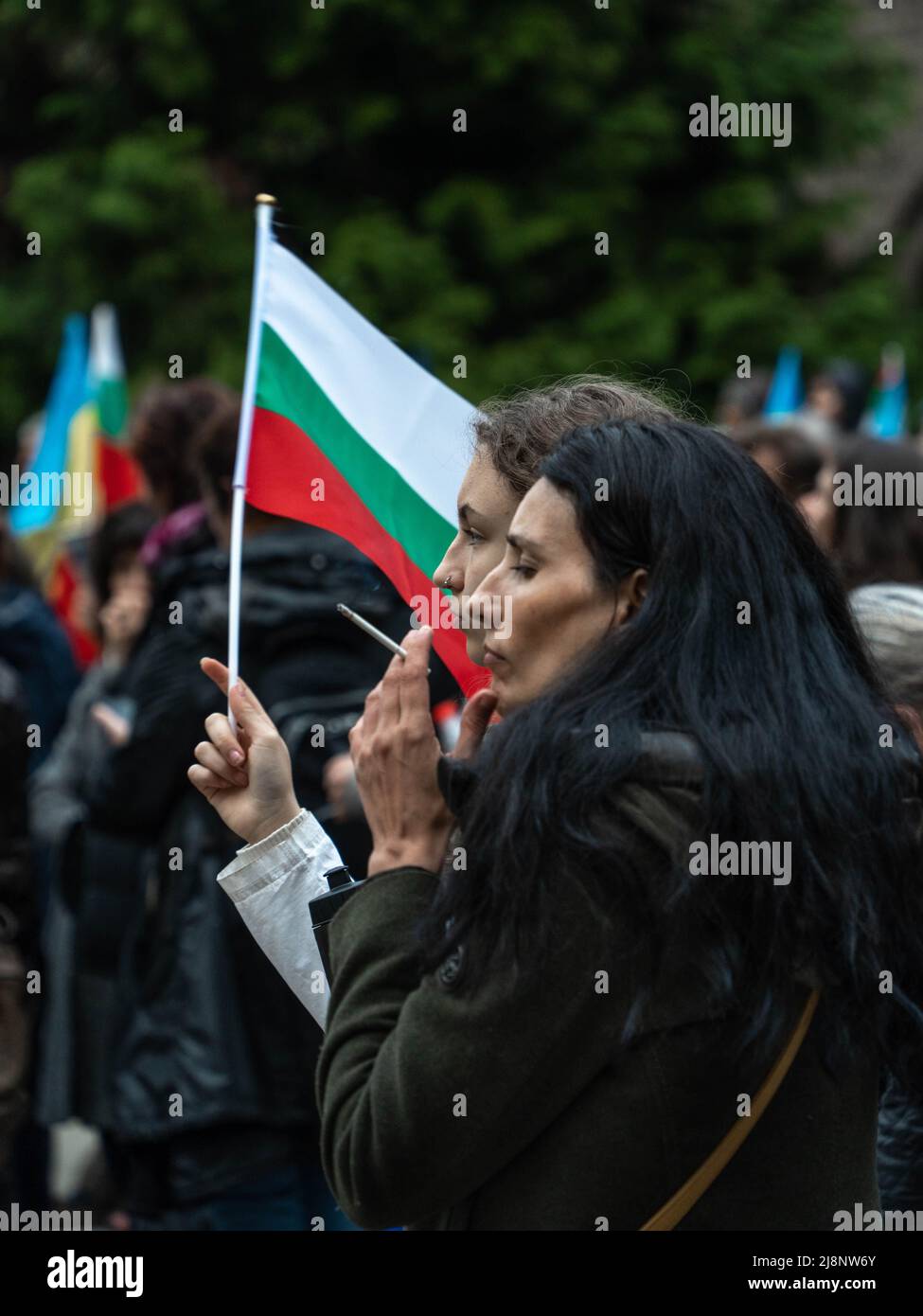 Sofia, Bulgaria - April 28, 2022: Two middle age women stand in a row with small Bulgarian flag at a demonstration Stock Photo