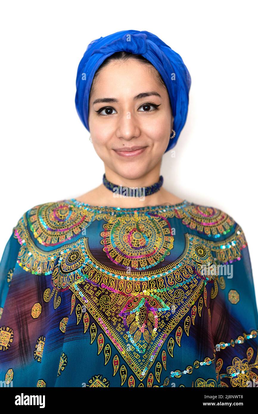 Portrait of beautiful young Muslim woman in traditional dress and turban isolated on white background. Concept of identity, different cultures and lif Stock Photo