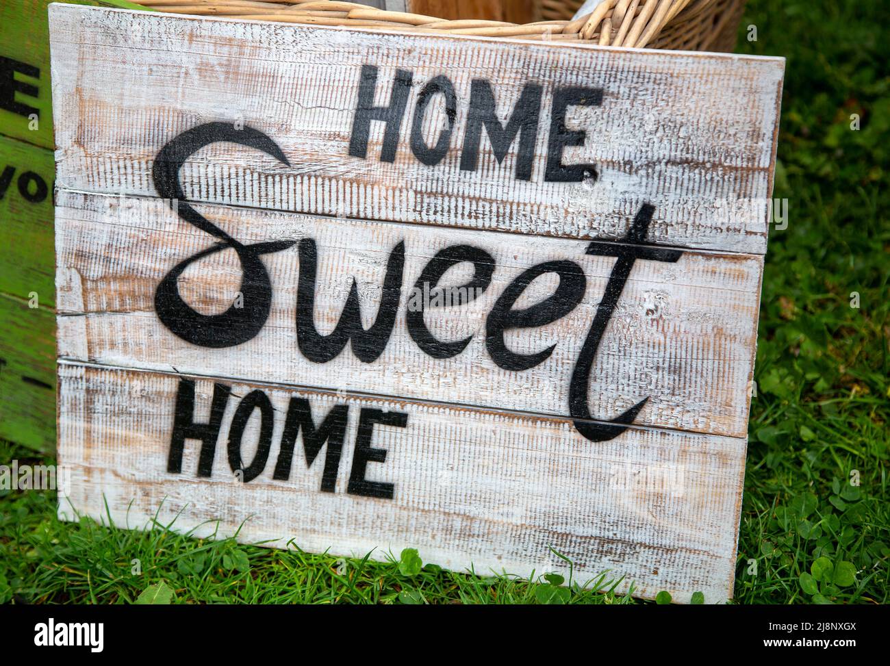 Old weathered sign with the phrase 'Home sweet home' Stock Photo