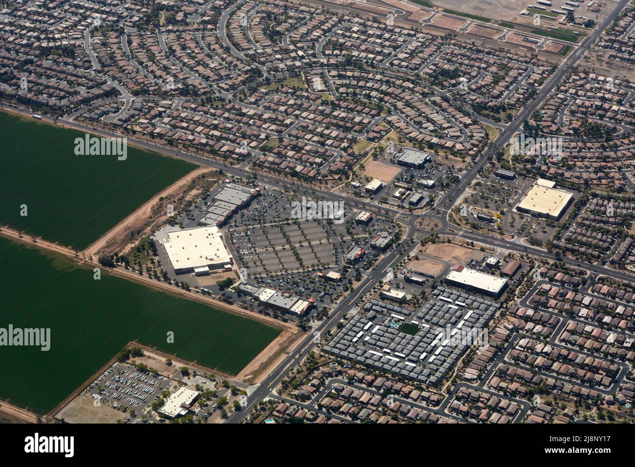 Aerial view of Tolleson, Arizona, and Pecan Promenade Shoppng Mall surrounded by housing and agricultural fields. Stock Photo