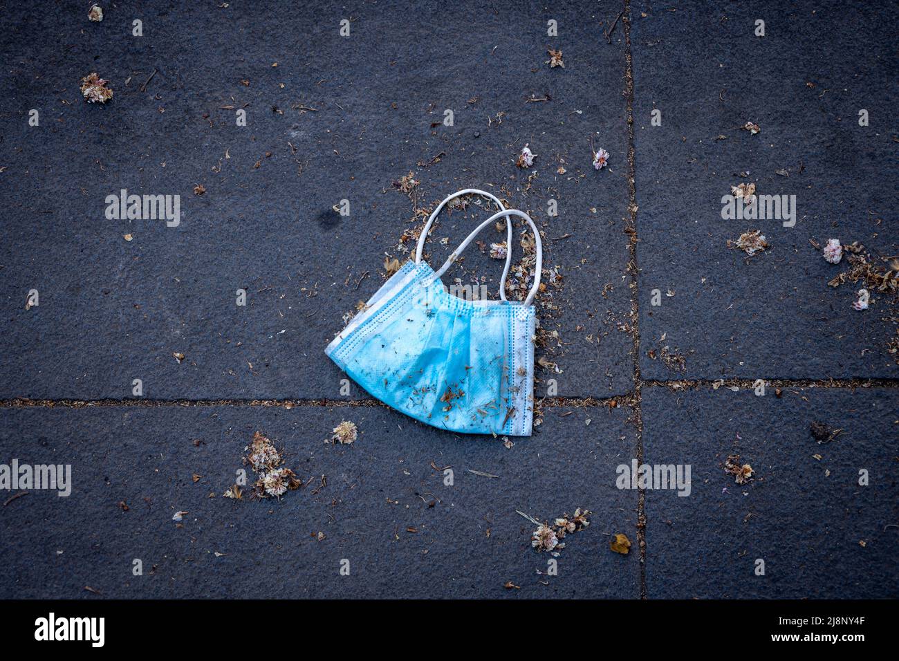 New post-pandemic garbage. Face masks thrown in the streets after the end of the restrictions. New pathogenic residues. Stock Photo