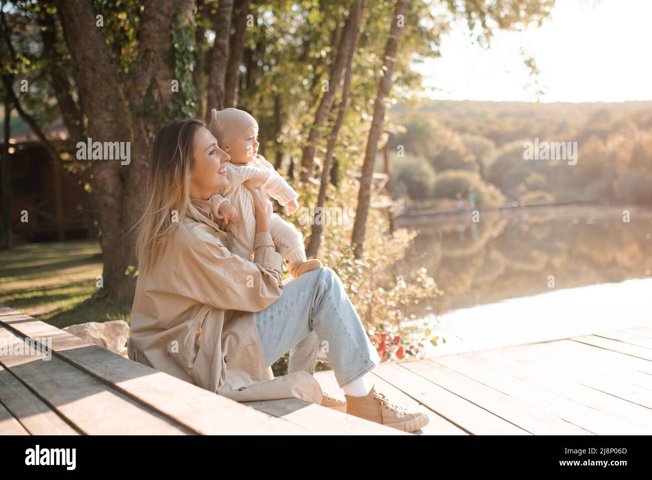 Smiling young mother playing with baby boy 1 year old wear casual