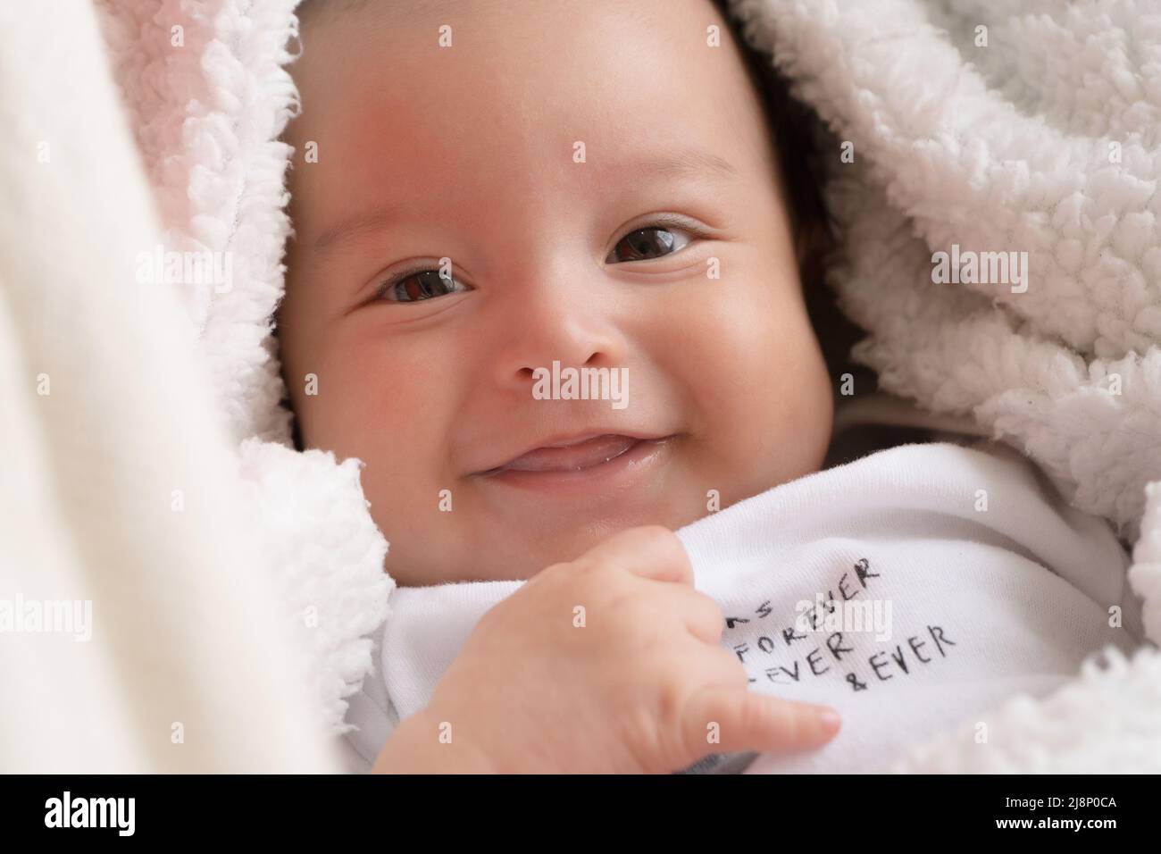 Latin baby happy at bed with a hat Stock Photo