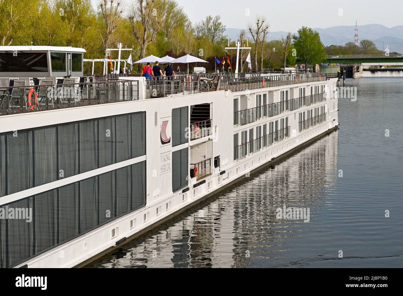 Breisach, Germany - April 2022: People on the top deck of a Viking river cruise ship moored in Breisach. Stock Photo