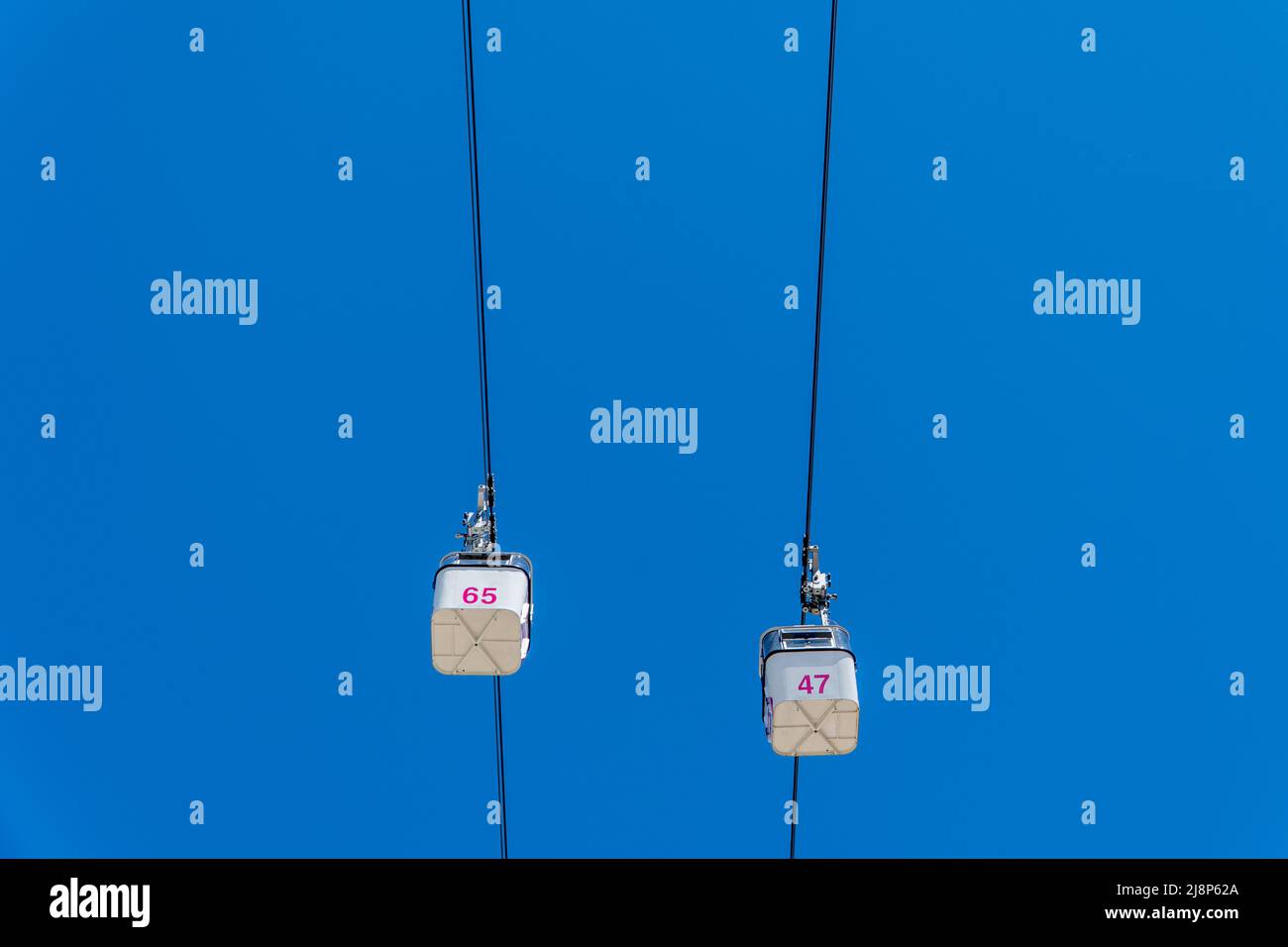 cable car cabin on blue sky background seen from below Stock Photo - Alamy