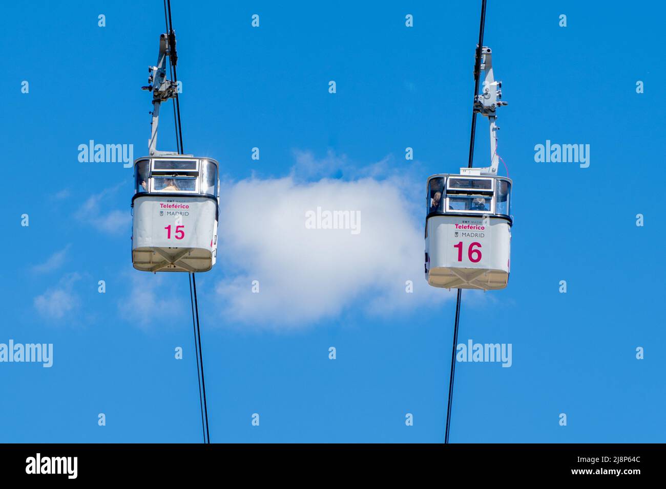 Madrid, Spain; 04242022 two cabins of the Madrid cable car cross each other while their