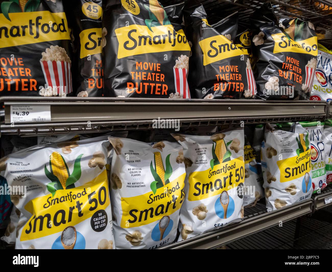 Mill Creek, WA USA - circa May 2022: Angled view of Smartfood brand popcorn for sale inside the chip aisle of a Town and Country grocery store Stock Photo