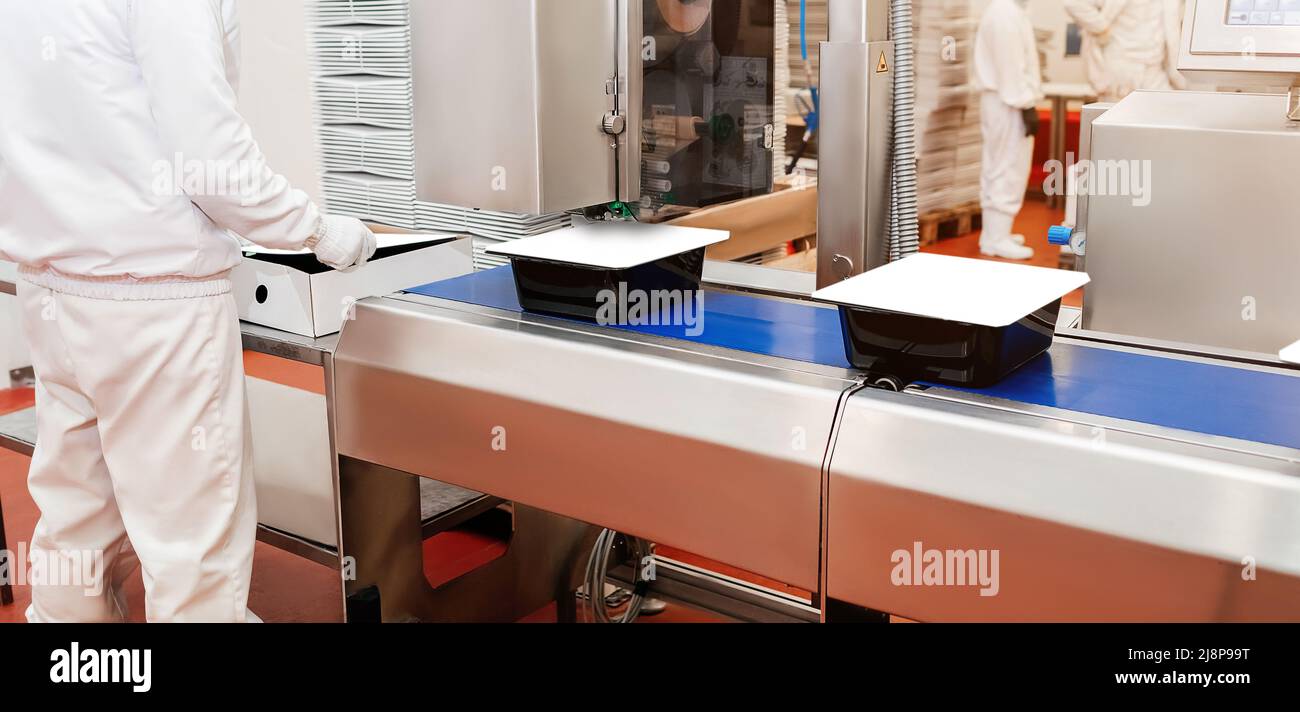 Factory Cook Production process, packaging on the conveyor line of meat in boxes ...