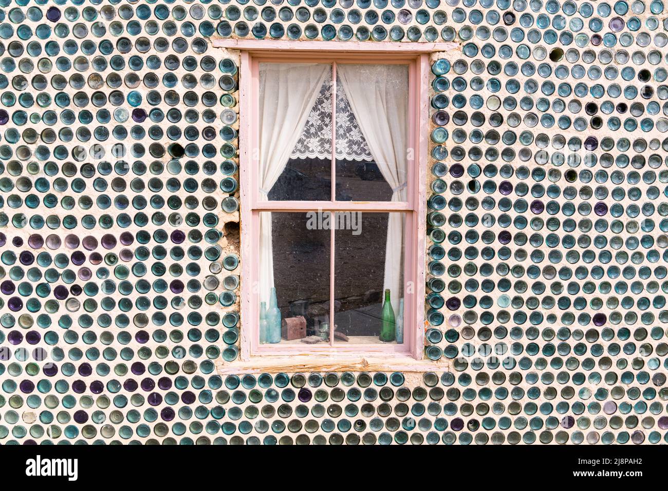 Rhyolite, NV,  - March 4, 2022 : Window on unique house constructed of bottles by Tom Kelly in 1906 in the mining town of Rhyolite, Nevada Stock Photo