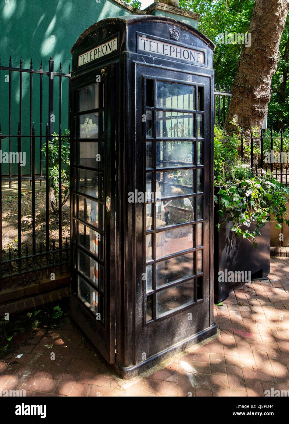 Black-painted telephone box opposite Charing Cross station, London Stock Photo