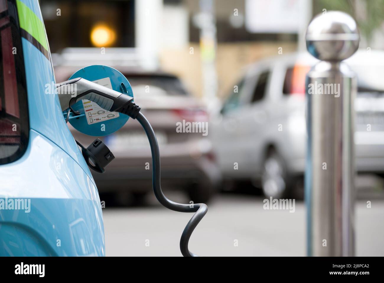 Car charging in the street Stock Photo - Alamy