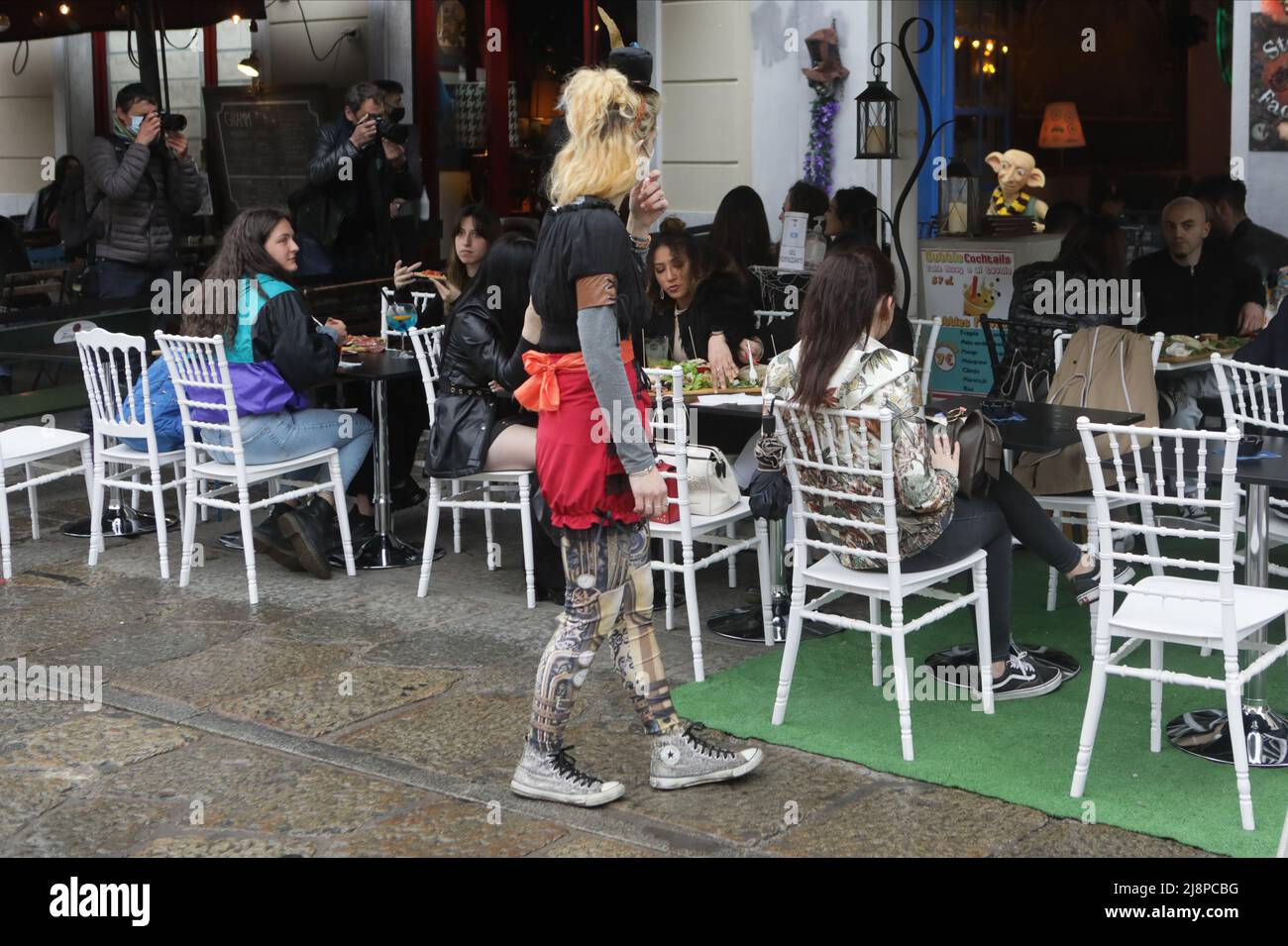 People have a drink on a bar terrace at the Navigli in downtown Milan on April 26, 2021 as bars, restaurants, cinemas and concert halls partially reopen across Italy in a boost for coronavirus-hit businesses Featuring: Atmosphere Where: Milan, Italy When: 26 Apr 2021 Credit: Mairo Cinquetti/WENN Stock Photo