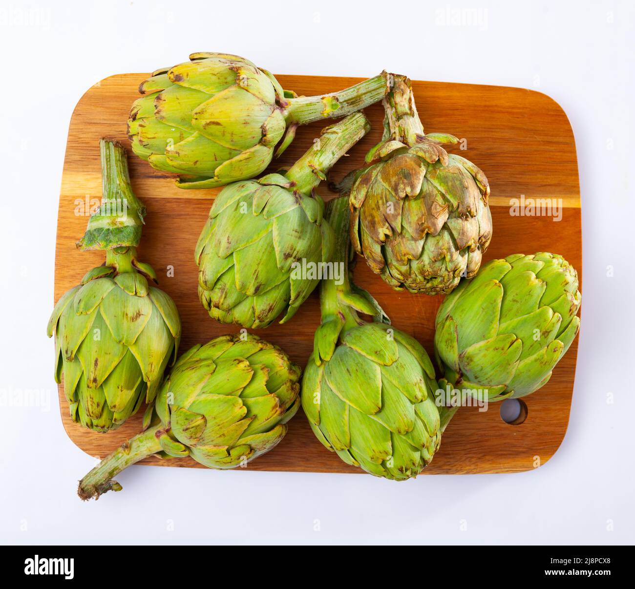 Artichokes with cutting board and knife hires stock photography and