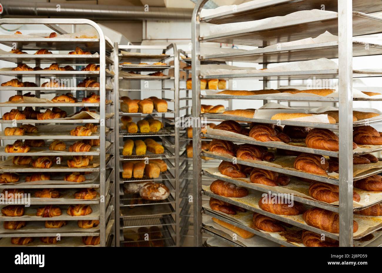 Freshly baked bread on trolley in bakery Stock Photo