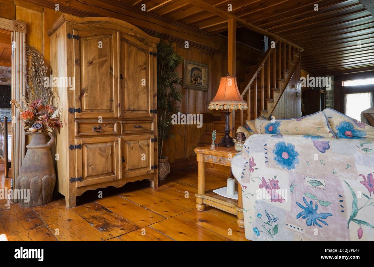 Antique reproduction armoire and furnishings in living room inside old
