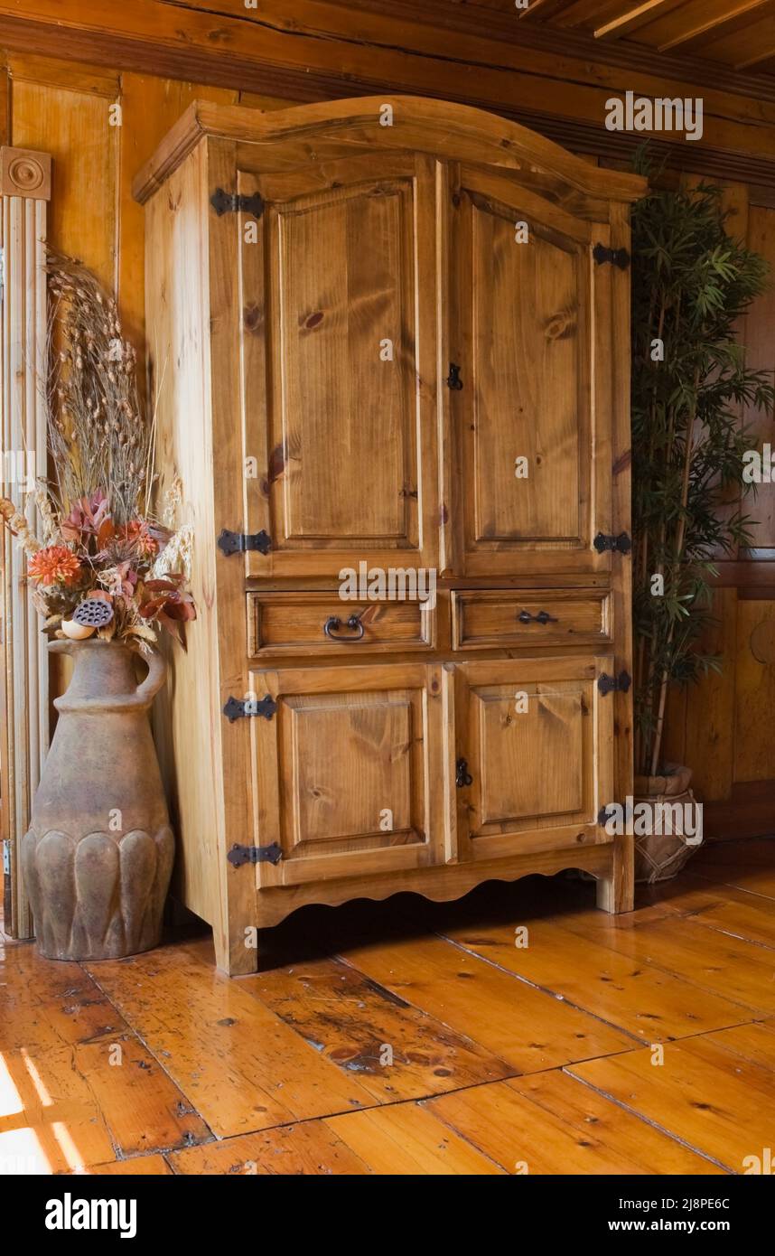 Antique pine wood reproduction armoire and furnishings in living room