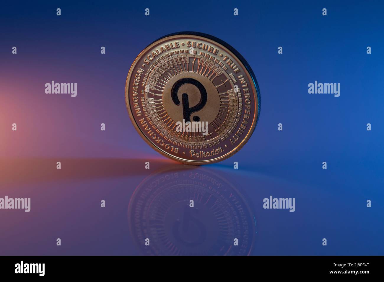 Polkador DOT Cryptocurrency physical coin placed on reflective surface and  lit with orange and blue lights. Macro Shot. Selective Focus Stock Photo -  Alamy