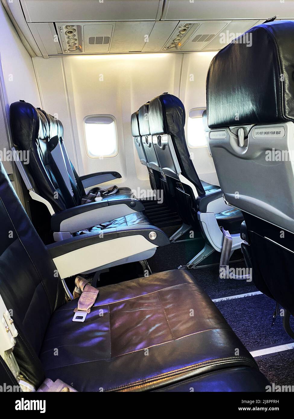 A row of empty seats on an airplane Stock Photo - Alamy