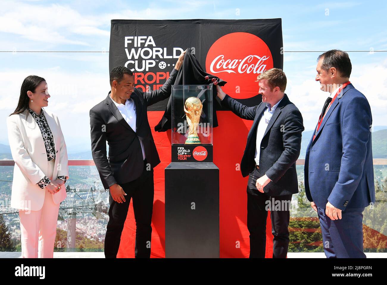 Sarajevo, FIFA World Cup Trophy Tour in Sarajevo. 17th May, 2022. Gilberto Silva (2nd L), former Brazilian football player, unveils the trophy during the FIFA World Cup Trophy Tour in Sarajevo, Bosnia and Herzegovina (BiH) on May 17, 2022. Credit: Nedim Grabovica/Xinhua/Alamy Live News Stock Photo