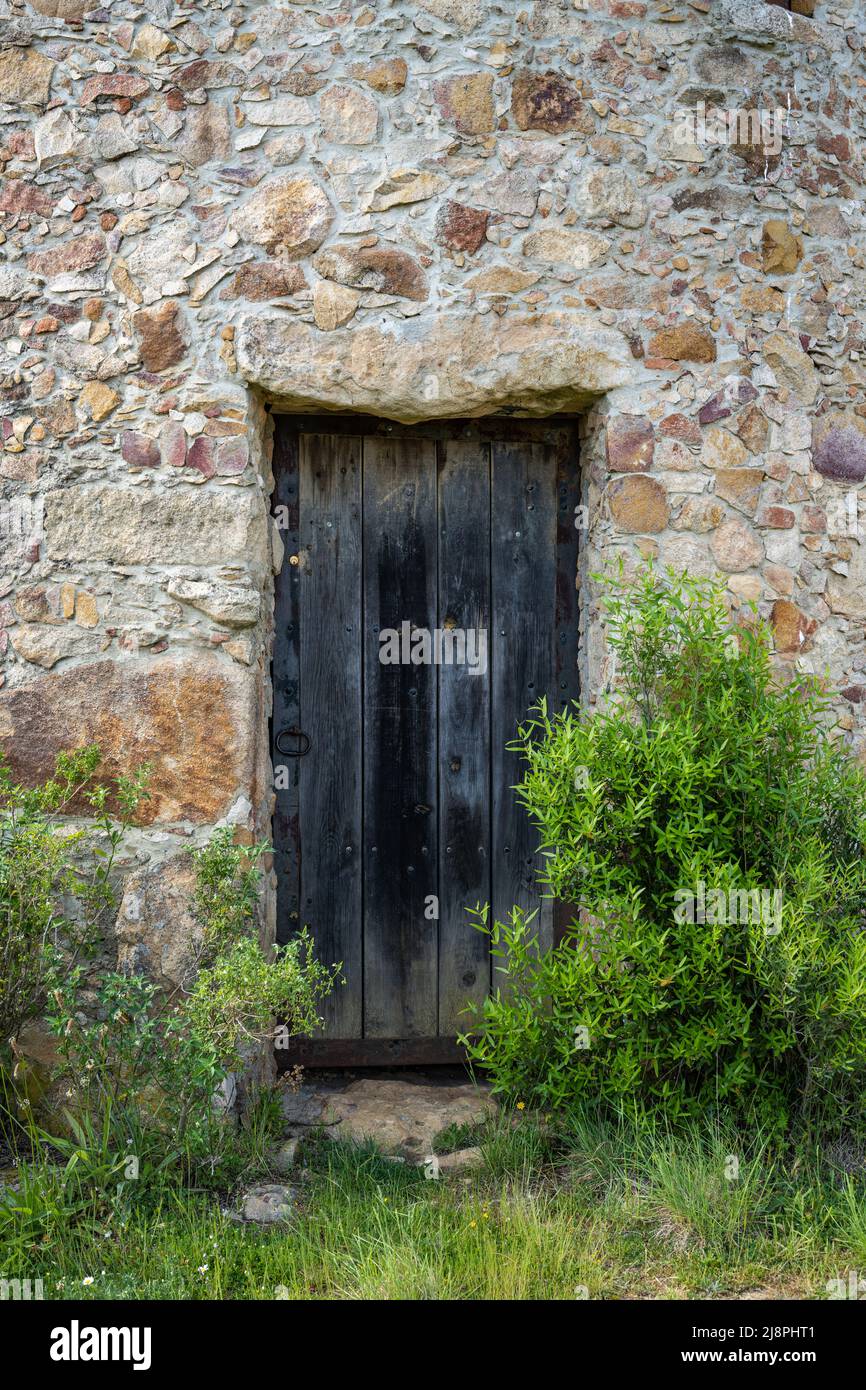 Ancient wooden door in stone wall Stock Photo - Alamy