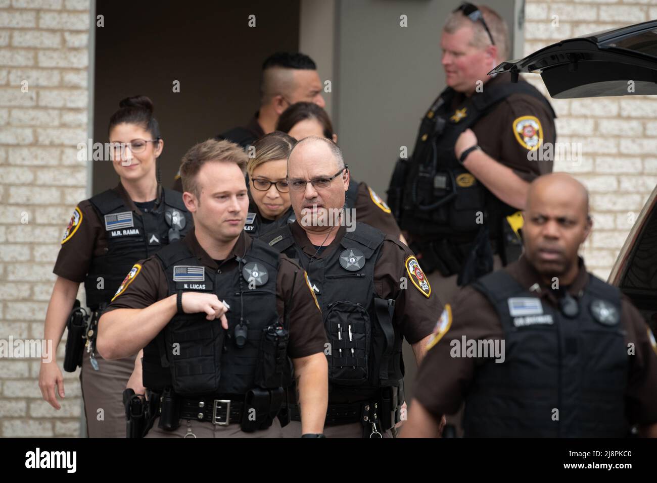 Fairfax County Sheriff's Deputies exit the courthouse to provide crowd control for Johnny Depp and Amber Hearts departure from the Fairfax County Courthouse, in Fairfax, at the close of another day in his civil trial with Amber Heard, Thursday, May 5, 2022. Depp brought a defamation lawsuit against his former wife, actress Amber Heard, after she wrote an op-ed in The Washington Post in 2018 that, without naming Depp, accused him of domestic abuse.Credit: Cliff Owen/CNP/Sipa USA (RESTRICTION: NO New York or New Jersey Newspapers or newspapers within a 75 mile radius of New York City) Stock Photo