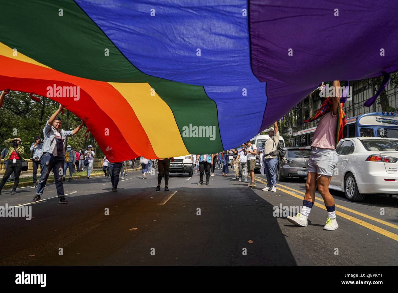 Protestors hold a pride flag during a demonstration for the rights of ...