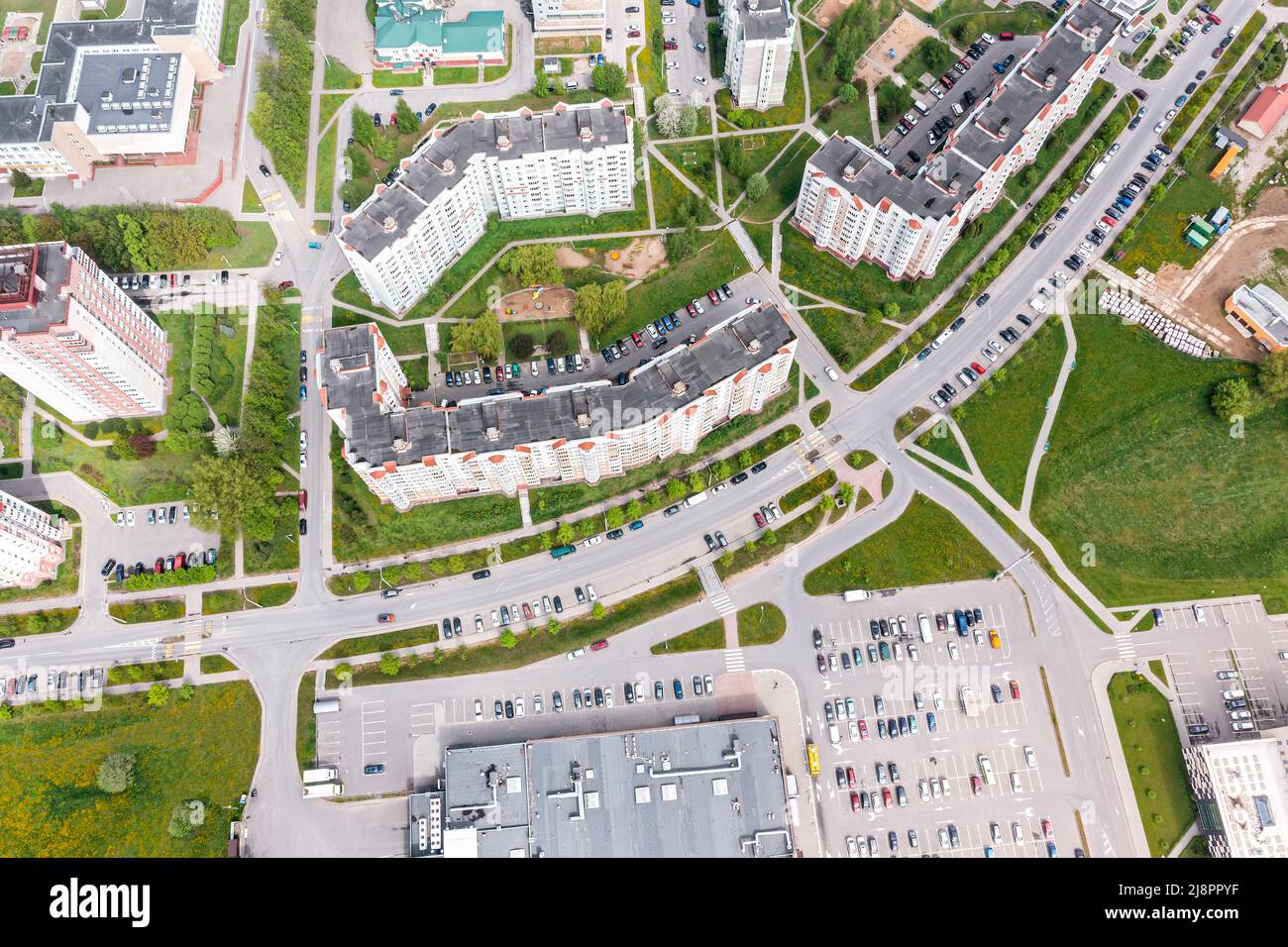 aerial view of city residential area with shopping center and parking lot with cars Stock Photo