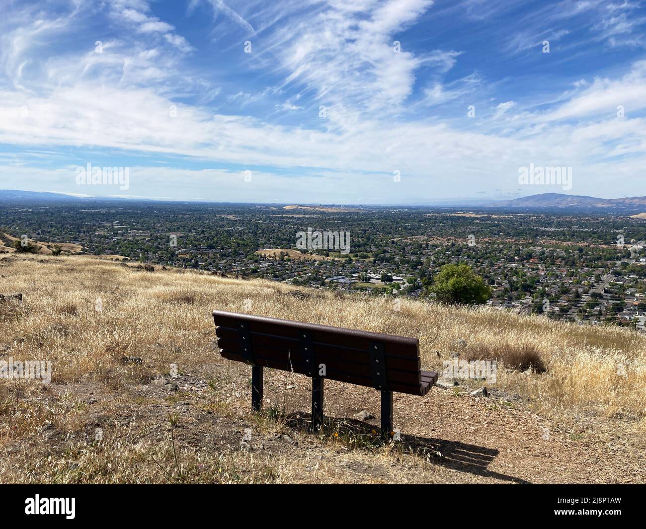 Bench with scenic aerial view of Silicon Valley residential neighborhood from Bernal Hill in Santa Teresa County Park. Stock Photo