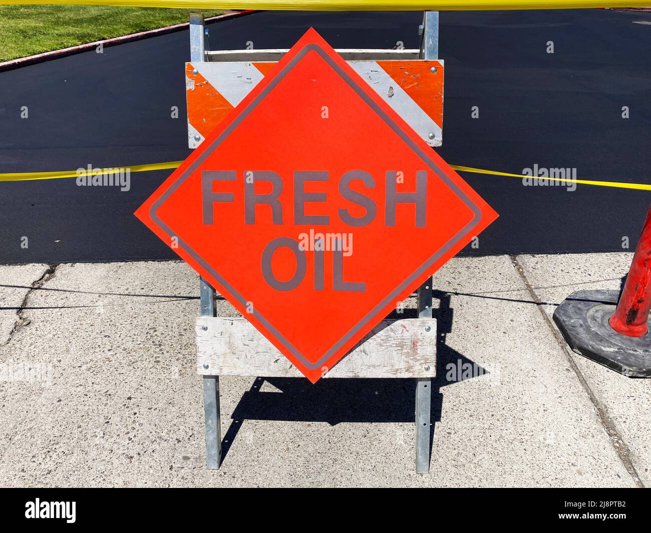 Fresh Oil sign at a newly completed outdoor parking lot. Stock Photo