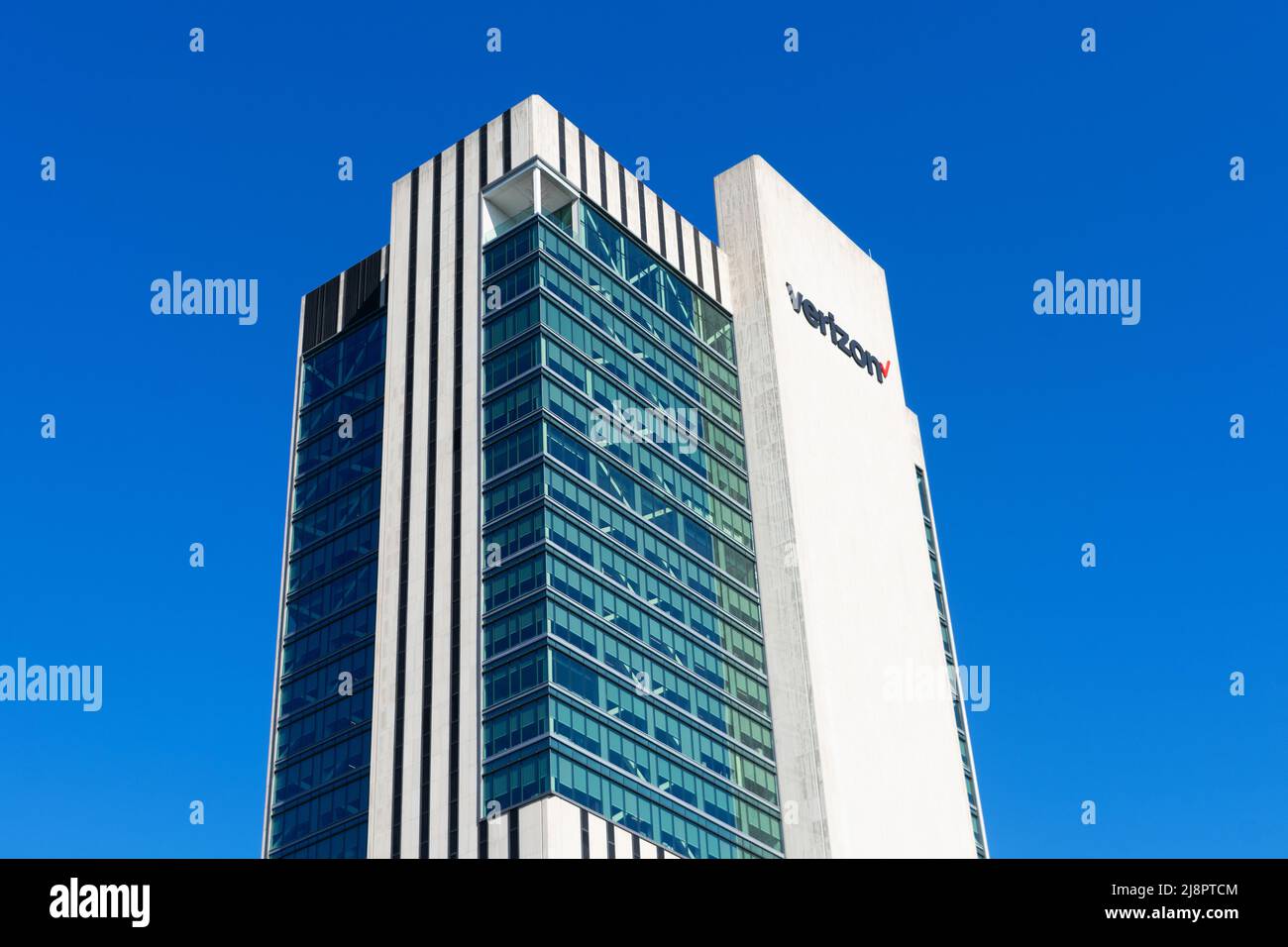 Verizon sign, logo on headquarters building exterior in Manhattan. Blue sky - New York, USA - 2022 Stock Photo