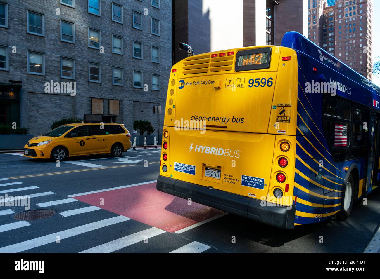 Rear side view of New York City Bus of Metropolitan Transportation Authority. Clean energy hybrid bus - New York, USA - 2022 Stock Photo