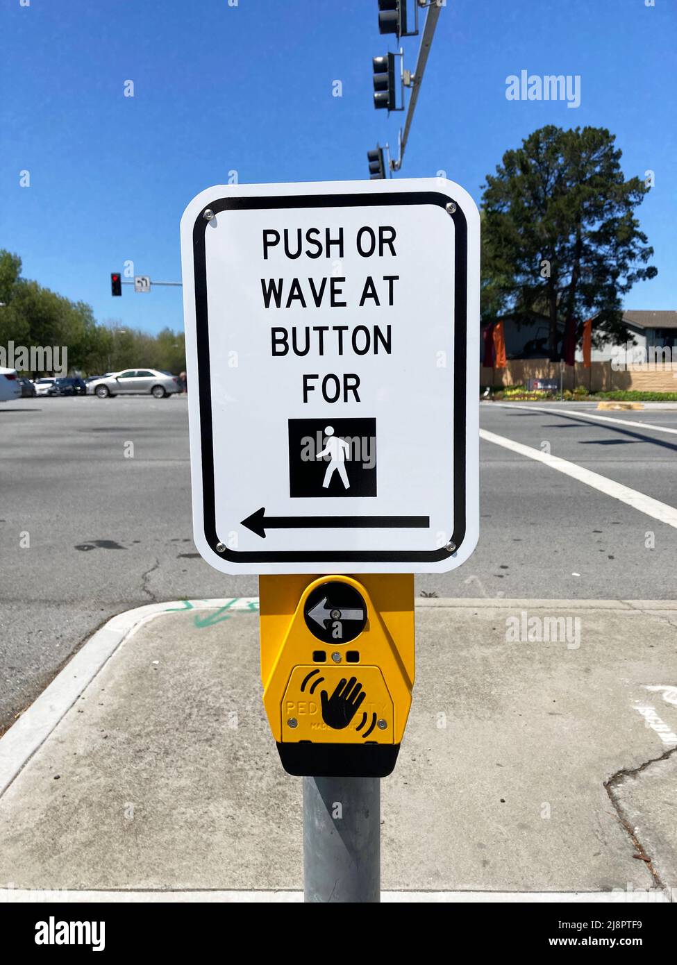 Pedestrian crosswalk, Push or Wave At Button, installed at traffic lights with a dedicated pedestrian signal Stock Photo