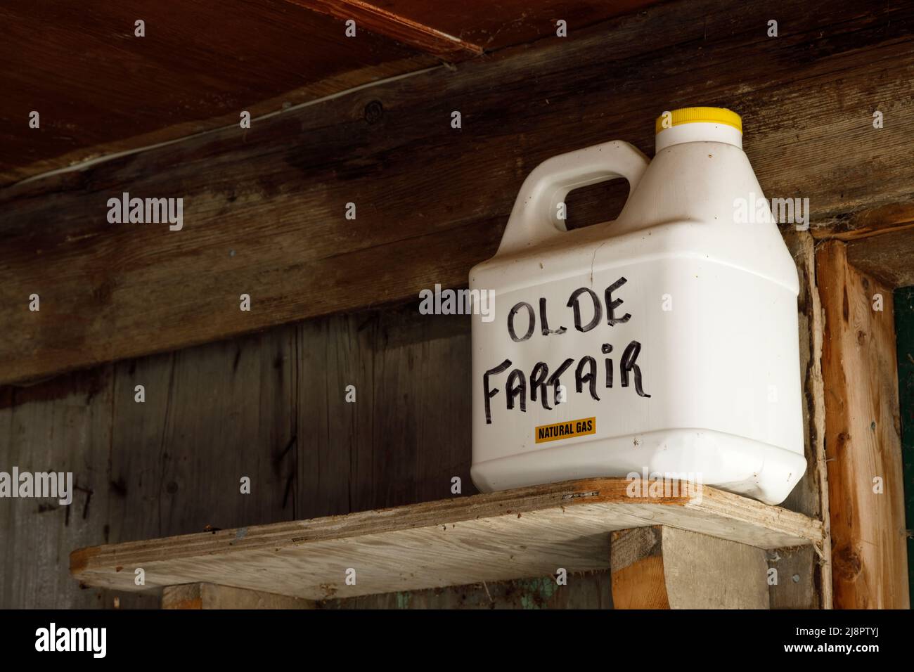 A plastic bottle that is labeled 'Olde Fart Air' on a shelf. This home has since been demolished. Stock Photo