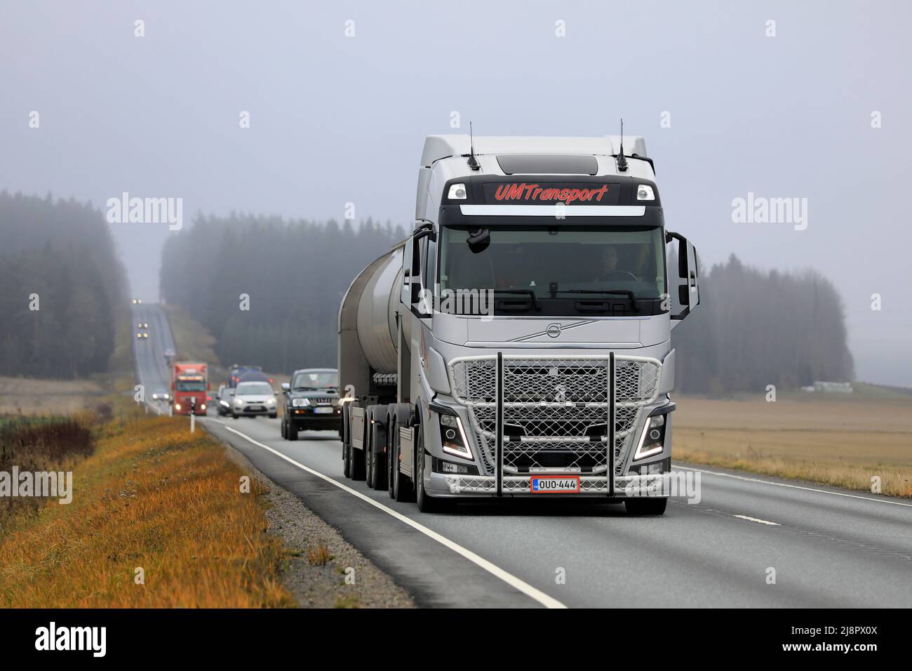Silver Volvo FH truck and tank trailer of UM Transport Ab in highway 2 traffic on a foggy day of autumn. Humppila, Finland. October 20, 2020. Stock Photo