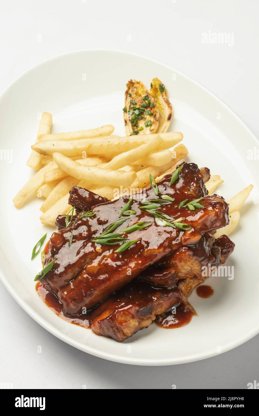 sweet and sour pork ribs in honey and soy sauce on white background Stock Photo