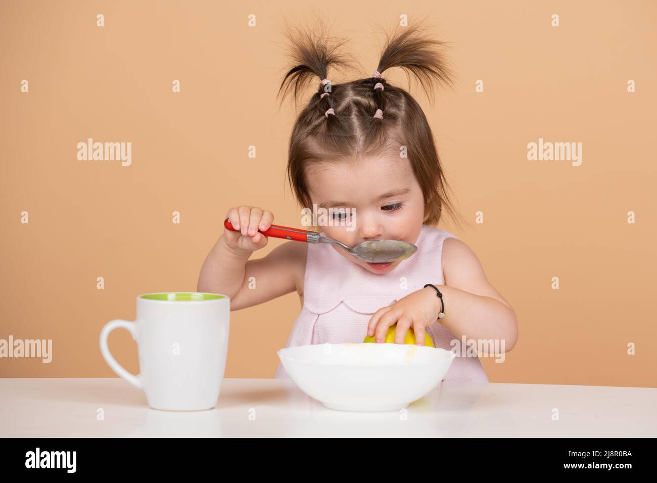 Cute funny babies eating, baby food. Little baby eating fruit puree Stock Photo Alamy