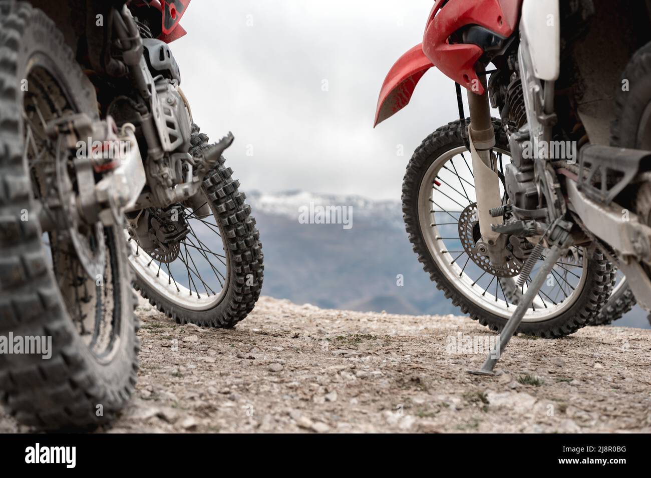 Two enduro cross motorbikes parked in mountains Stock Photo